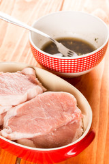 Selective focus on pork chops with barbecue marinade in the back