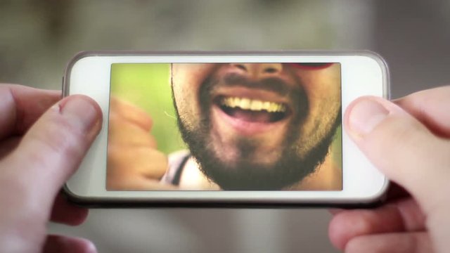 Video chatting with young urban hipster Millennial man over smartphone