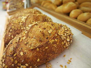 bread and buns in on shelf in bakery or baker's shop