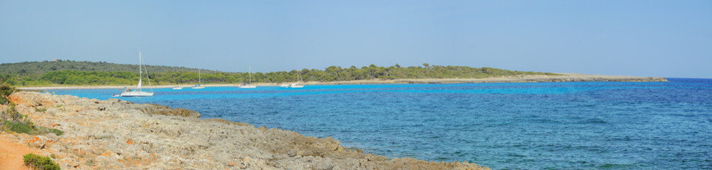 Fototapeta na wymiar Menorca Son Saura. Bellavista beach. Turquoise and green colors at Balearic islands