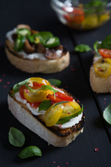 Bruschetta with cherry tomatoes, cream cheese, mushrooms, basil