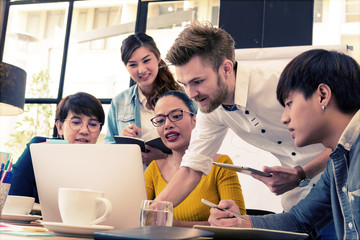 Smart handsome european man business officer explaining internal meeting to his project team in modern office. They are the multi ethnic business person group in casual suit. Business concept.