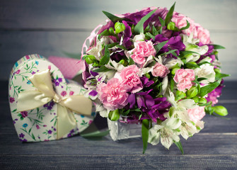 Wedding bouquet. Carnation, eustoma. Gift box in the form of heart. Background of old tree. Selective focus.