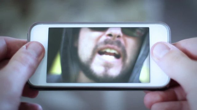 Cyber Bullying concept - angry mean bully yells at person over the internet from smartphone