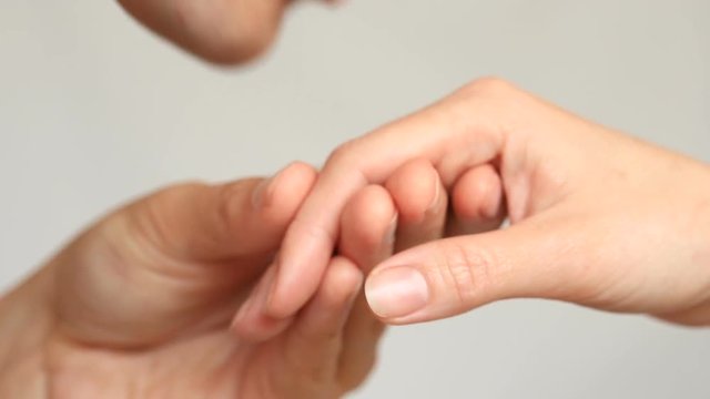 Close-up of a kiss for hands. The man kisses the woman's hand. Isolated over white background