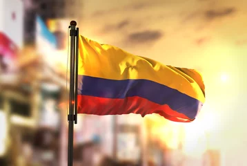 Fototapeten Colombia Flag Against City Blurred Background At Sunrise Backlight © natanaelginting