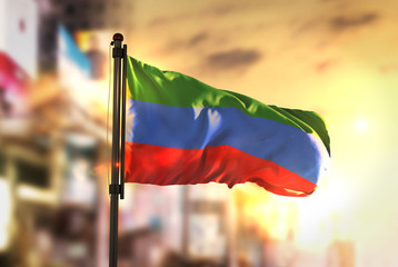 Republic of Dagestan Flag Against City Blurred Background At Sunrise Backlight