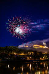 Firework in city above water and castle