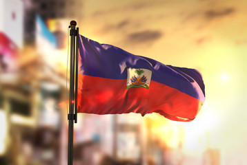 Haiti Flag Against City Blurred Background At Sunrise Backlight