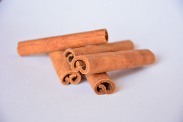 five cinnamon sticks on light background closeup