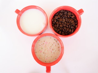 Three cups with coffee sugar and milk