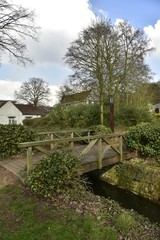 Fototapeta premium Le petit pont en bois traversant la Woluwe derrière le moulin à eau de Lindekemale à Woluwe-St-Lambert