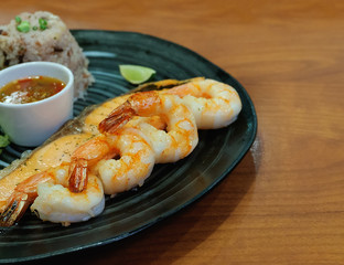 golden delicious grilled shrimp steak on black plate