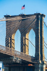 Fototapeta premium American flag on top of Brooklyn Bridge New York
