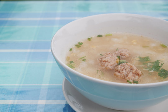 porridge or rice porridge pork in white bowl on blue floor cloth