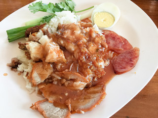 red pork over rice served with white plate