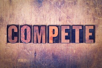 Compete Theme Letterpress Word on Wood Background