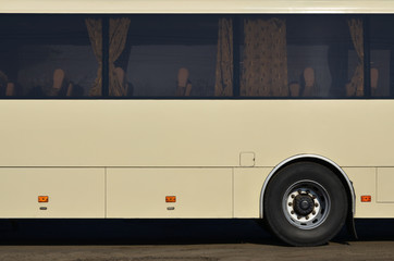 Photo of the hull of a large and long yellow bus with free space for advertising. Close-up side view of a passenger vehicle for transportation and tourism © mehaniq41