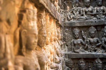 Khmer wall with statues on sunshine