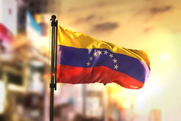 Foto op Aluminium Venezuela Flag Against City Blurred Background At Sunrise Backlight © natanaelginting