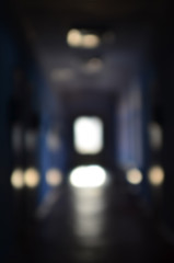 The blurred image of gloomy corridor of a neglected public building. Defocused picture of a public...