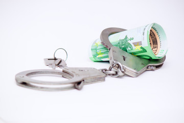 Handcuffs and euro bills. Crime concept