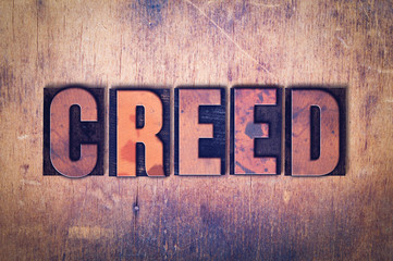 Creed Theme Letterpress Word on Wood Background - obrazy, fototapety, plakaty