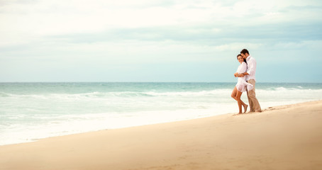 Fototapeta na wymiar Couple embracing on beach