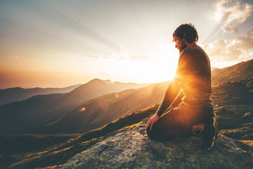 Man relaxing at sunset mountains Travel Lifestyle spiritual awakening emotional meditating concept vacations outdoor harmony with nature landscape