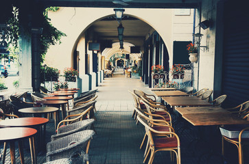 Coffee shops and restaurants getting ready for tourists early in the morning. The scenic old town of Bellagio, Lake Como, Italy. European vacation, life style, architecture and travel concept. 