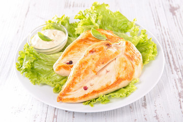 grilled chicken breast with salad and sauce