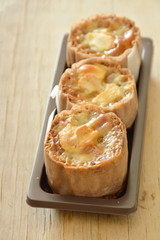 mini batter cupcake paper wrapped topping custard cream and chew nut on plastic tray 