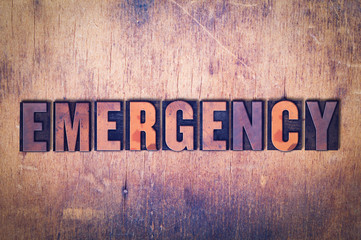 Emergency Theme Letterpress Word on Wood Background