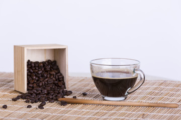 Coffee cup and coffee beans on table