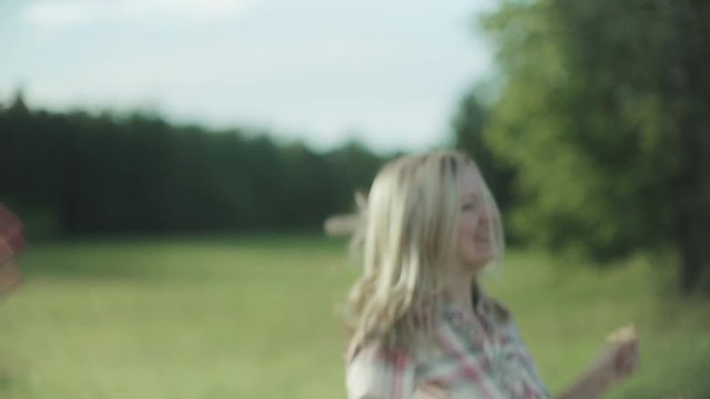 Happy Couple Having Fun Outdoors. Laughing Joyful Family. Freedom Concept. Healthy Joyful Young Man and Woman together. Slow Motion Video Footage 4k