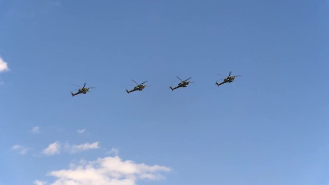 Combat helicopters Mi-28 fly in blue sky