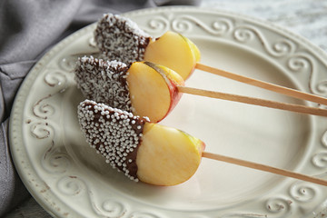 Plate with candied apple wedges on sticks