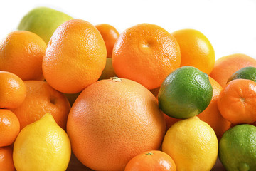 Heap of juicy citrus fruits on white background, closeup