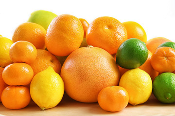 Heap of juicy citrus fruits on white background, closeup