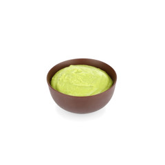 Bowl of delicious wasabi sauce isolated on white