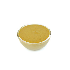 Bowl of delicious mustard sauce isolated on white
