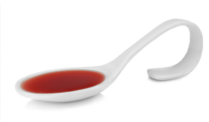 Spoon with delicious strawberry sauce isolated on white