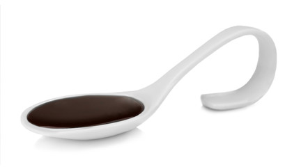Spoon with delicious chocolate sauce isolated on white
