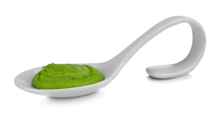 Spoon with delicious wasabi sauce isolated on white