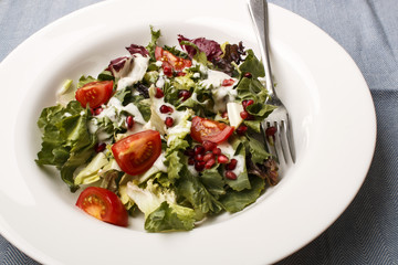 fresh summer salad with tomato and pomegranate seed