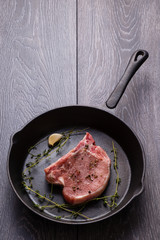 raw pork chop in pan