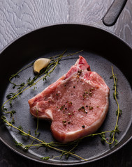 raw pork chop in pan