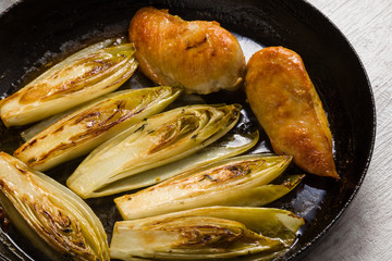fried chicken and chicory in sauce