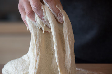 Kneading sourdough for rustic bread