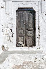 Shabby old gray painted front door on Greek Island Santorini